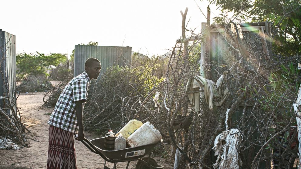 PHOTO: Mohamed Abukar gathers water for his family in Dadaab refugee camp in Kenya. Mohamed is a refugee who came to Dadaab camp with his wife Habiba and their two daughters during the 2011 drought. 